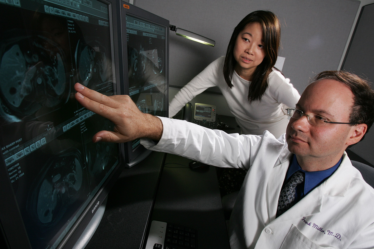 Photo of radiologist and resident looking at monitor