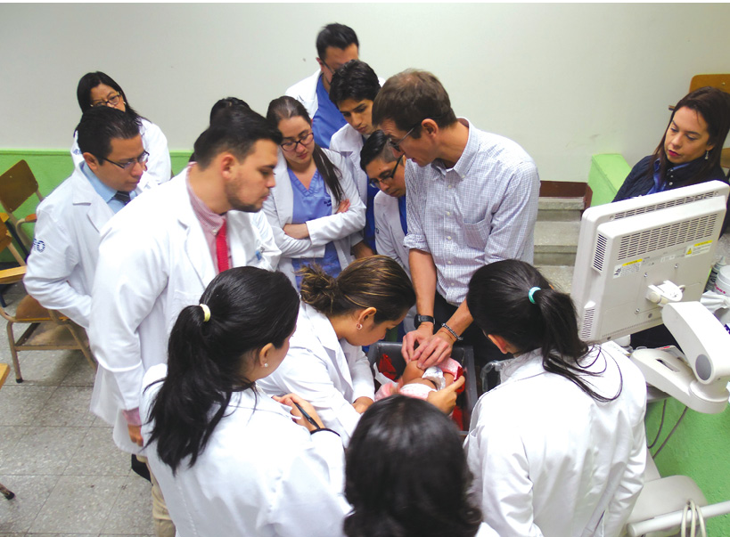 Ramon Sanchez, MD, consults with radiology residents