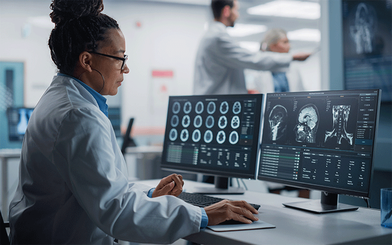 Computer screen with brain scans viewed by female radiologist