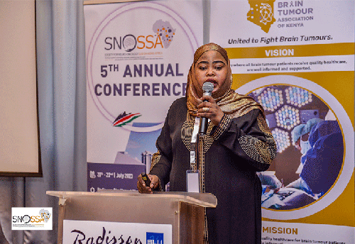 Candid photo of Ugumba Mussa Kwikima MD MMed MSc speaking at SNOSSA conference