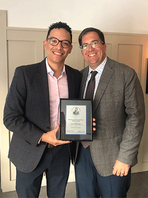 Cesar Alvarado MD stands with Jason C. Hoffman, MD and receives his 2023 Roentgen Resident/Fellow Research Award