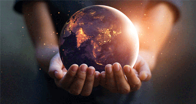 Image of a globe held in the palms of two hands with golden light coming from within and a point of bright light highlighting the upper exterior 