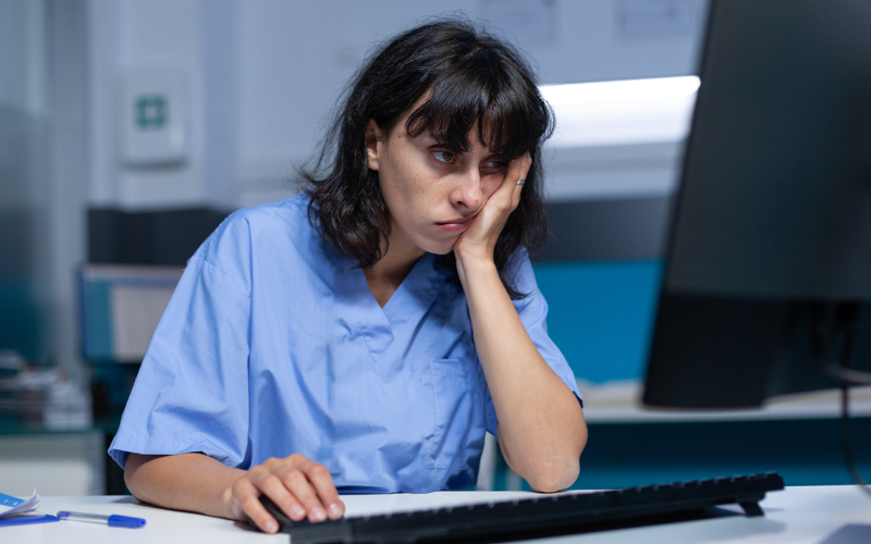 Medical specialist falling asleep at desk