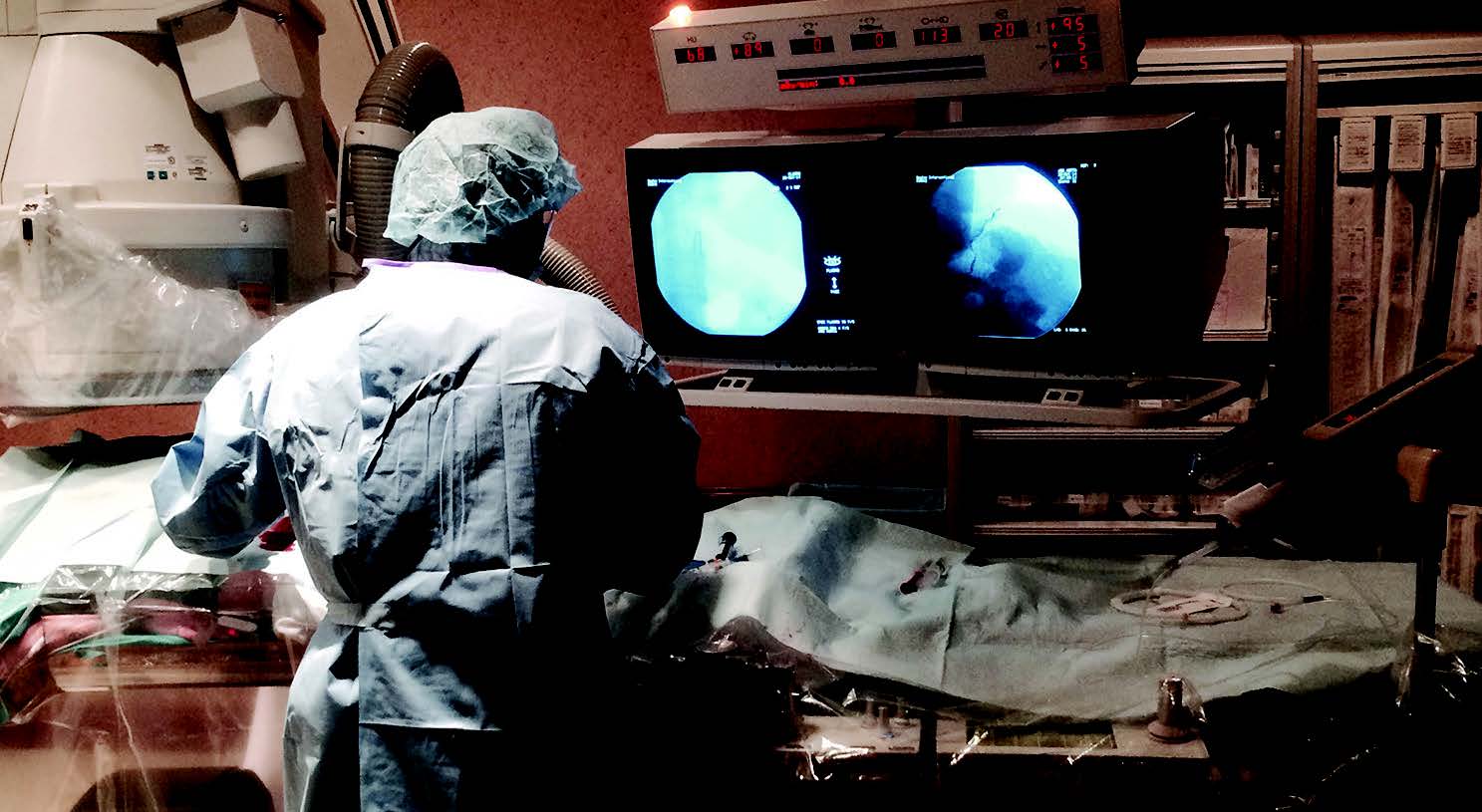 A doctor performing gastric artery embolization on a patient. A doctor performing gastric artery embolization on a patient.