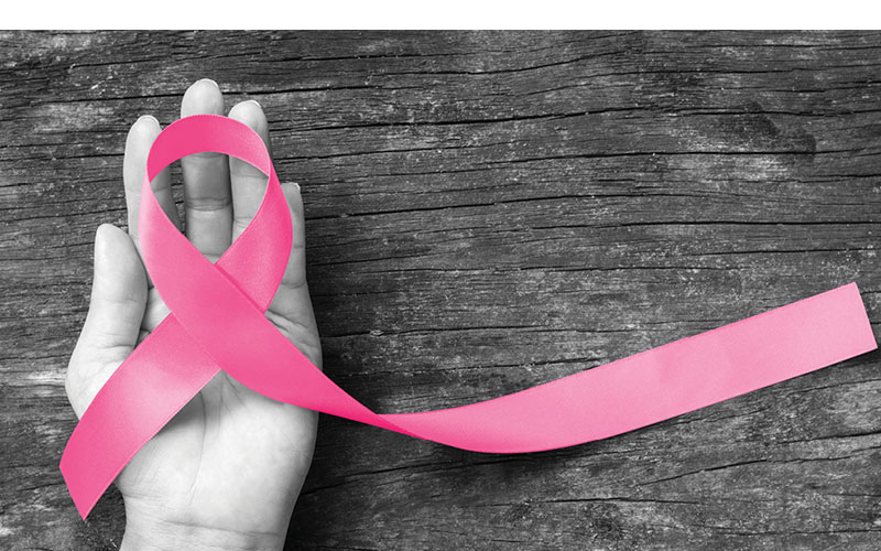 hand and pink ribbon feature