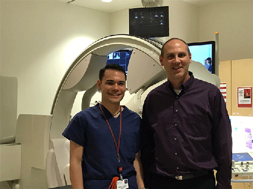 Brandon K.K. Fields stands next to George R. Matcuk, Jr., in a radiology suite