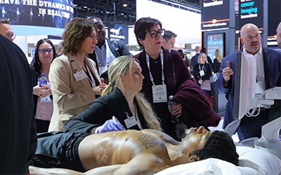 A small group gathers for a demonstration in the Technical Exhibits halls