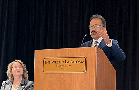 M. Mahesh, PhD, MS, at a podium speaking during a conference