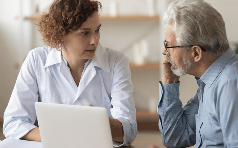 older patient with radiologist at computer