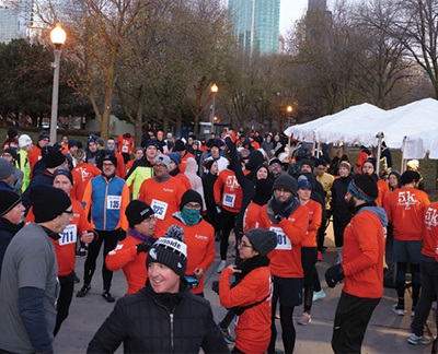 Crowd of runners in orange shirts