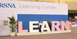 People posing with large format letters that spell LEARN in the Learning Center at the RSNA annual meeting
