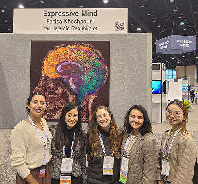 Elena Greco, MD, and Parisa Khoshpouri, MD, pose in front of an Art of Imaging exhibit at RSNA 2023