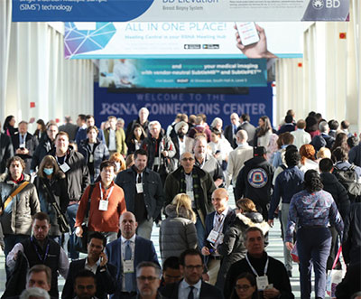 Large crowd of attendees crossing bridge at McCormick Place during RSNA annual meeting