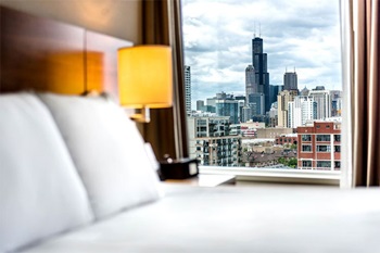 Hotel room with view of downtown Chicago in window