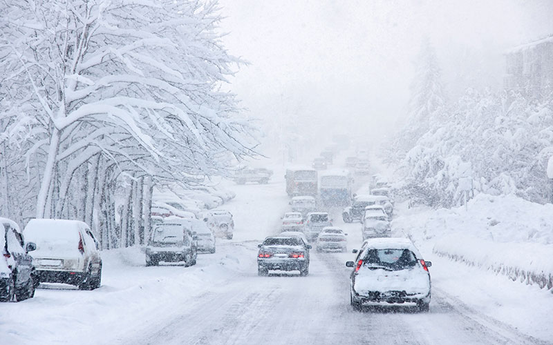 Several cars stranded on a snowy road.