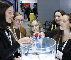 Five women around a 3D model of a heart.