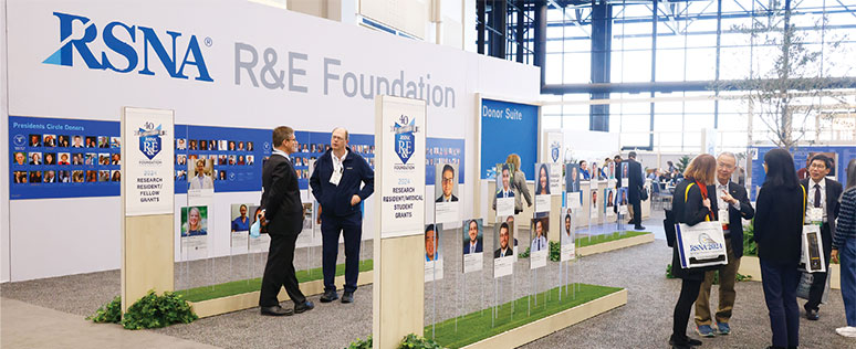 People gather around the R&E Foundation booth at the RSNA annual meeting. 