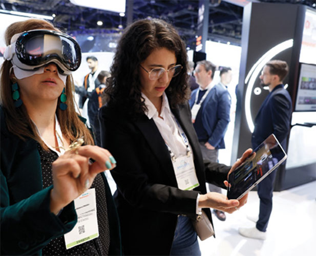 Two women work with a virtual reality device