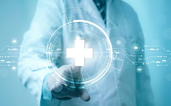 Doctor in white coat points at stylized white cross on screen.