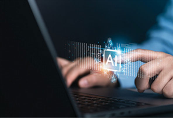 Person working at laptop points at AI on screen. 