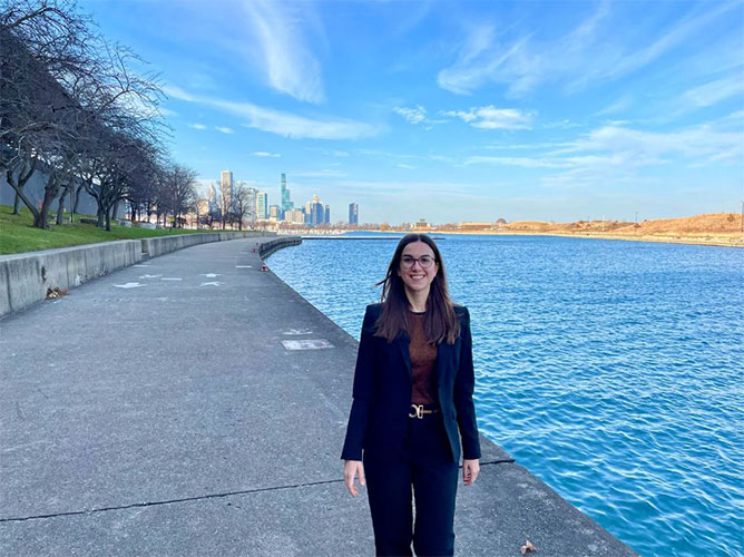 Nadine Bayerl, MD, standing along the Chicago lakefront with Lake Michigan and the city skyline in the background.