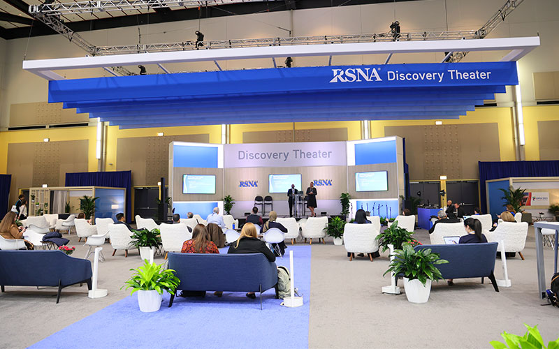 People sit in the seating viewing the Discovery Theater stage at the RSNA annual meeting.